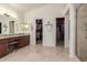 Bathroom features a dual sink vanity with lots of counter space and access to walk in closet and shower at 4937 W Desert Hollow Dr, Phoenix, AZ 85083