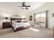 Spacious bedroom with vaulted ceiling, ceiling fan, natural light, and comfortable seating area at 4937 W Desert Hollow Dr, Phoenix, AZ 85083