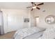 Bright bedroom featuring carpet, ceiling fan, closet, and television at 4937 W Desert Hollow Dr, Phoenix, AZ 85083