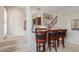 Open-concept dining area with bar stools, wooden trim and staircase at 4937 W Desert Hollow Dr, Phoenix, AZ 85083