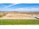 Wide aerial view of a driving range with golfers practicing, set against a desert backdrop at 4937 W Desert Hollow Dr, Phoenix, AZ 85083