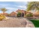 Well-maintained home with a three-car garage, desert landscaping, and paved walkway at 4937 W Desert Hollow Dr, Phoenix, AZ 85083