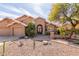 Charming Southwestern-style home features a well-kept yard with desert landscaping and an inviting front entrance at 4937 W Desert Hollow Dr, Phoenix, AZ 85083