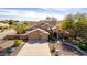 Charming home featuring a manicured lawn, desert landscaping, and an arched entryway at 4937 W Desert Hollow Dr, Phoenix, AZ 85083