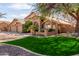Attractive home with a well-maintained lawn, mature trees, and tasteful landscaping at 4937 W Desert Hollow Dr, Phoenix, AZ 85083