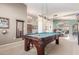Game room with a pool table and a chandelier provides ample space for entertainment and relaxation at 4937 W Desert Hollow Dr, Phoenix, AZ 85083