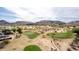 Aerial shot of a well-maintained golf course with lush greens surrounded by desert landscape at 4937 W Desert Hollow Dr, Phoenix, AZ 85083