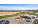 Expansive golf course view featuring a clubhouse, putting green, and golf carts under a sunny sky at 4937 W Desert Hollow Dr, Phoenix, AZ 85083