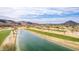 Wide aerial shot of a golf course with a tranquil lake and manicured green fairways at 4937 W Desert Hollow Dr, Phoenix, AZ 85083