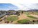 Scenic aerial view of golf course, parking lot, and surrounding mountain landscape at 4937 W Desert Hollow Dr, Phoenix, AZ 85083