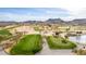 Picturesque aerial view of a sprawling golf course with a lake and mountain views at 4937 W Desert Hollow Dr, Phoenix, AZ 85083