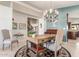 Inviting home office featuring a built-in desk, chandelier, and neutral decor at 4937 W Desert Hollow Dr, Phoenix, AZ 85083