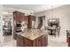 Open kitchen boasts granite countertops, stainless steel appliances, and a central island for seamless cooking at 4937 W Desert Hollow Dr, Phoenix, AZ 85083