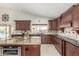 Well-lit kitchen with a granite island, ample counter space, modern appliances, and plenty of cabinet storage at 4937 W Desert Hollow Dr, Phoenix, AZ 85083