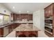 Modern kitchen features a spacious island with granite countertops, stainless steel appliances, and custom cabinetry at 4937 W Desert Hollow Dr, Phoenix, AZ 85083