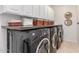 Functional laundry room with ample storage space, including modern washer and dryer units at 4937 W Desert Hollow Dr, Phoenix, AZ 85083