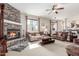 Cozy living room features a stone fireplace, comfortable seating, and natural light at 4937 W Desert Hollow Dr, Phoenix, AZ 85083