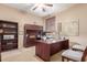 Comfortable home office with dark wood furniture, built-in shelves, and ample natural light at 4937 W Desert Hollow Dr, Phoenix, AZ 85083
