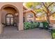 Cozy porch with decorative iron door and a seating area surrounded by lush greenery for relaxation at 4937 W Desert Hollow Dr, Phoenix, AZ 85083