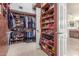 Spacious walk-in closet with custom shelving, shoe racks, and ample storage for clothes and accessories at 4937 W Desert Hollow Dr, Phoenix, AZ 85083