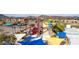 Colorful water slides rise above the park, offering thrilling adventures against a desert landscape backdrop at 4937 W Desert Hollow Dr, Phoenix, AZ 85083