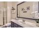 Bathroom featuring modern fixtures, a large decorative mirror, and a glass-enclosed shower at 5225 S Opal Pl, Chandler, AZ 85249