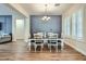 Dining room with modern chandelier, wainscoting and ample seating, perfect for Gathering meals at 5225 S Opal Pl, Chandler, AZ 85249