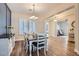 Well-lit dining room features a stylish chandelier, shutters, wood floors and view to an adjoining living area at 5225 S Opal Pl, Chandler, AZ 85249