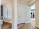 Bright foyer with wood flooring, a white front door, and views into adjacent rooms at 5225 S Opal Pl, Chandler, AZ 85249