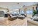 Bright living room with views to the kitchen featuring wood floors, modern furnishings and natural light at 5225 S Opal Pl, Chandler, AZ 85249