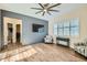 This well-lit living room features wood flooring, a ceiling fan, and a mounted television at 5225 S Opal Pl, Chandler, AZ 85249