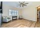 Bright living room features a large window, wood flooring, and ceiling fan at 5225 S Opal Pl, Chandler, AZ 85249
