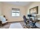 Functional home office features a large desk, comfortable seating, and natural light for a productive workspace at 5225 S Opal Pl, Chandler, AZ 85249
