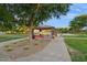 A park area featuring a red picnic table and shelter shaded by a lush, mature tree at 5225 S Opal Pl, Chandler, AZ 85249