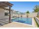 Backyard pool with tanning ledge, umbrellas, water feature, and perimeter landscaping at 5225 S Opal Pl, Chandler, AZ 85249