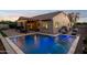 A gorgeous private pool is surrounded by a patio and covered dining area with outdoor lighting at 5225 S Opal Pl, Chandler, AZ 85249