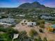 An impressive aerial shot highlighting the estate with mountain views amid landscaped grounds at 5539 N 68Th Pl, Paradise Valley, AZ 85253