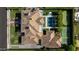 Aerial view showcasing a luxurious home with a pool, tennis court, and beautifully landscaped grounds at 5915 E Calle Del Sud --, Phoenix, AZ 85018