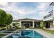 Picturesque backyard featuring a pool, ivy-covered walls, and stylish outdoor seating areas at 5915 E Calle Del Sud --, Phoenix, AZ 85018