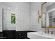 Modern bathroom showcasing black and white tile, gold accents, and a sleek floating sink at 5915 E Calle Del Sud --, Phoenix, AZ 85018