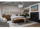 Cozy bedroom features a fireplace, soft colors, and a comfortable sitting area at 5915 E Calle Del Sud --, Phoenix, AZ 85018