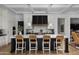 Gourmet kitchen with black and white cabinetry, a center island, and pendant lighting at 5915 E Calle Del Sud --, Phoenix, AZ 85018