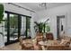 Comfortable living room with rattan furniture, a plant, and views of the pool at 5915 E Calle Del Sud --, Phoenix, AZ 85018