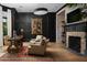 Stylish home office featuring black paneled walls, fireplace, and elegant decor at 5915 E Calle Del Sud --, Phoenix, AZ 85018