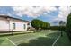 Lush tennis court set against a backdrop of mature trees and a beautiful home at 5915 E Calle Del Sud --, Phoenix, AZ 85018