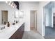 A bathroom with a double sink, a white countertop and wood cabinets and hardware at 651 N Ironwood Dr # 2, Apache Junction, AZ 85120