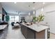 Modern kitchen open to the living room, featuring a large island with pendant lighting and stainless steel appliances at 651 N Ironwood Dr # 2, Apache Junction, AZ 85120