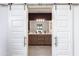 Beautiful bathroom with double sink vanity, a large mirror, and sliding barn doors at 651 N Ironwood Dr # 3, Apache Junction, AZ 85120