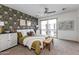 Stunning main bedroom with patterned accent wall, sliding glass doors, and stylish decor at 651 N Ironwood Dr # 3, Apache Junction, AZ 85120