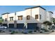 Modern townhome exterior with dark garage doors and drought-resistant landscaping at 651 N Ironwood Dr # 3, Apache Junction, AZ 85120